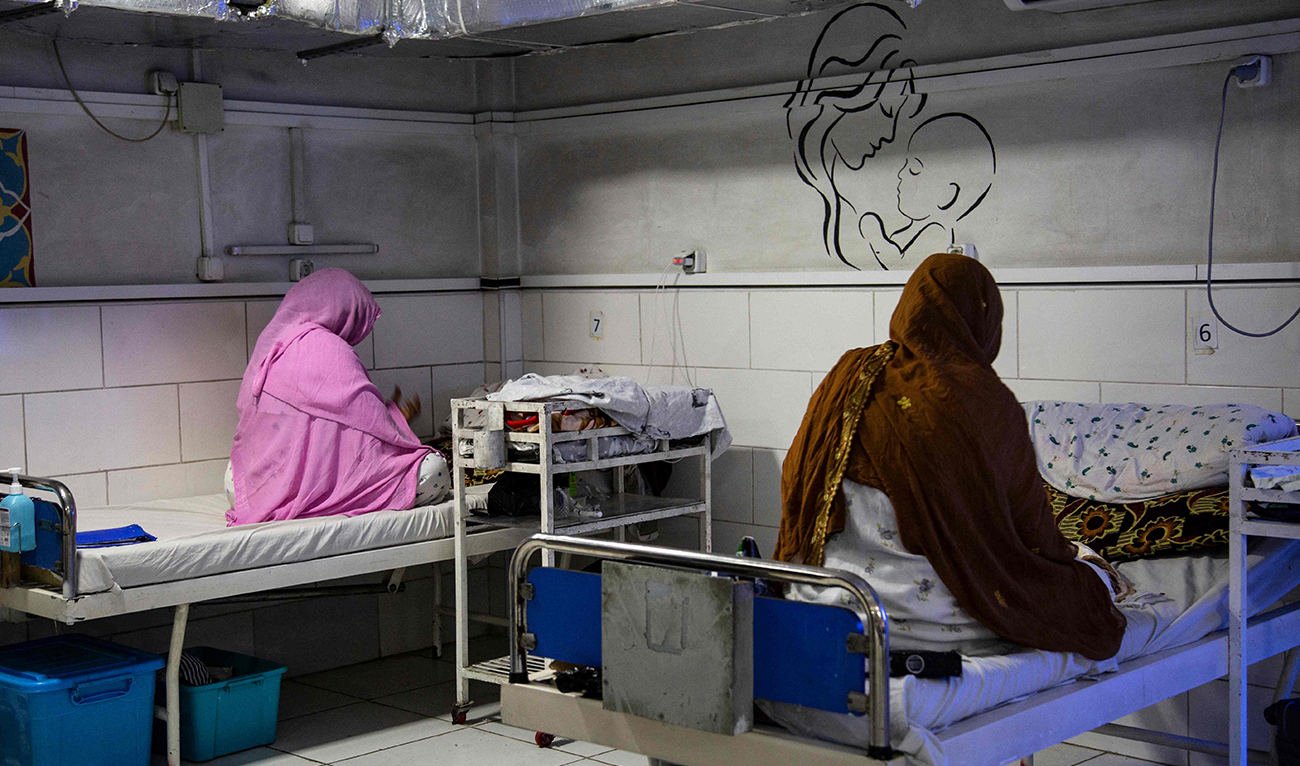 In this photograph taken on December 8, 2023, Afghan women sit beside their newborns at the Doctors Without Borders (MSF)-run maternity hospital in Khost, Afghanistan. (AFP/File)