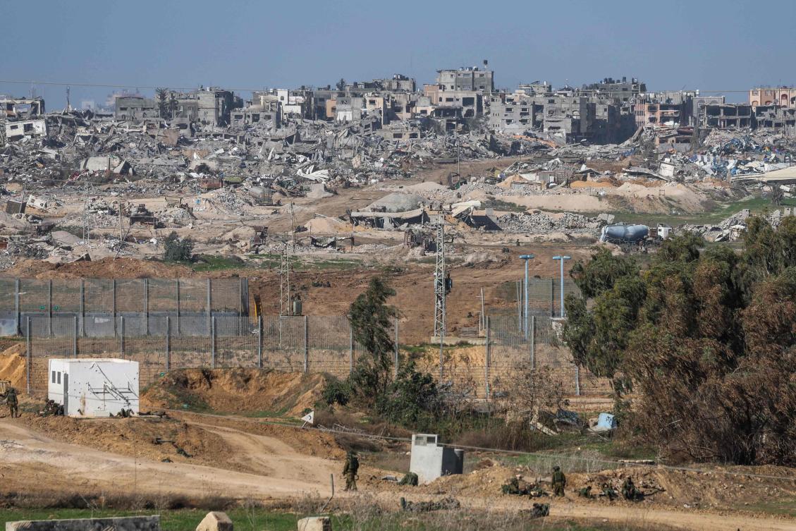 A picture taken from southern Israel bordering the Gaza Strip on Dec. 22, 2023, shows Israeli soldiers waiting at the entrance of the border amid ongoing battles with Hamas. (AFP)