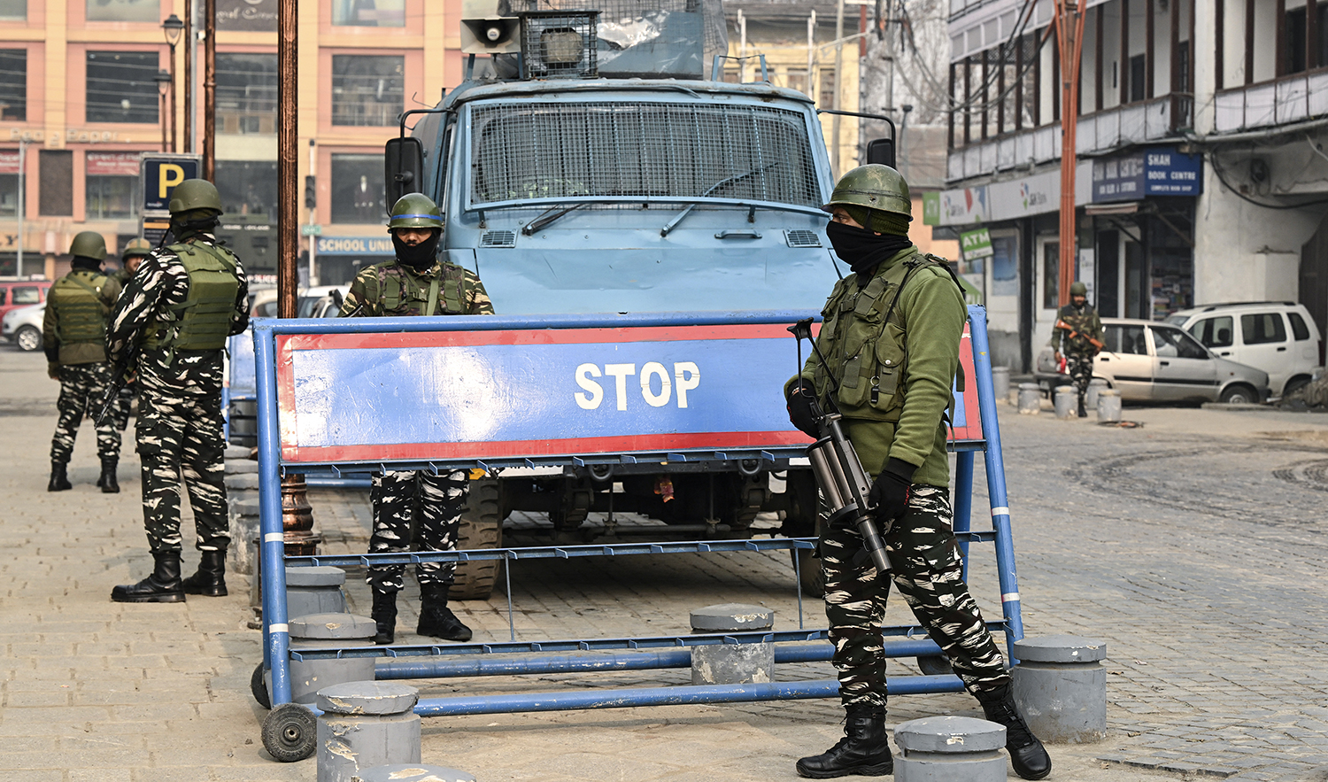 Indian paramilitary personnel stand guard along a road in Srinagar on December 11, 2023. (AFP)