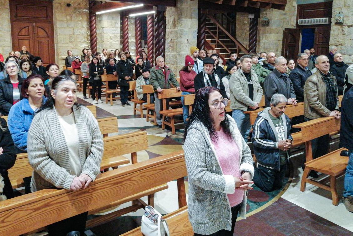 Faithful attend a Christmas mass at a church in the village of Qlayaa, on the southern border with Israel, on Dec. 21, 2023, amid ongoing cross-border tensions as fighting continues between Israel and Hamas. (AFP)