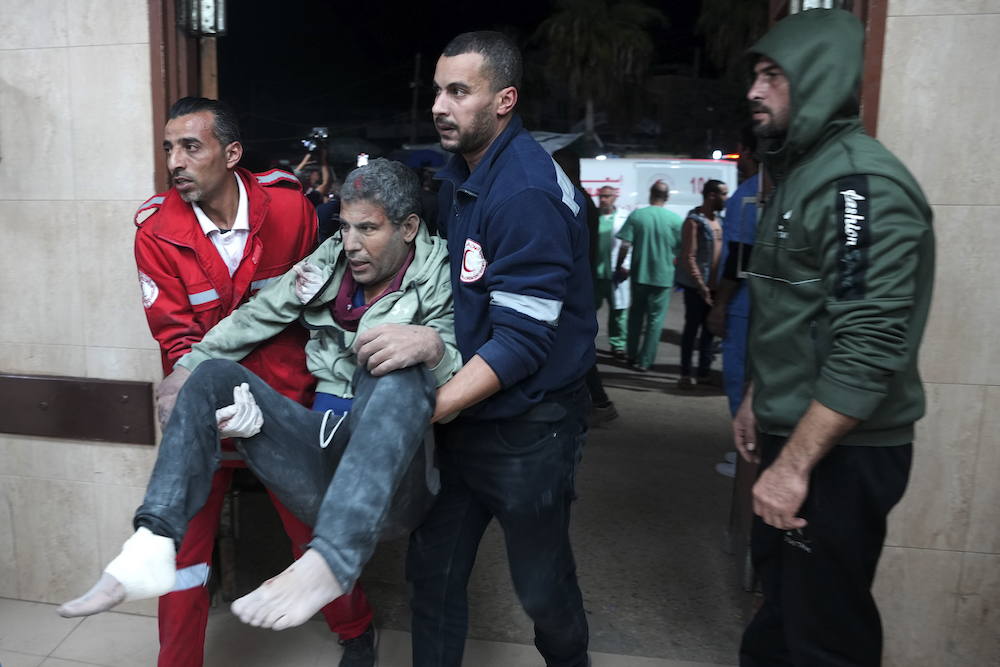 Palestinians wounded in the Israeli bombardment of the Gaza Strip are brought to the hospital in Deir Al-Balah, Gaza Strip, on Tuesday, Dec. 19, 2023. (AP)