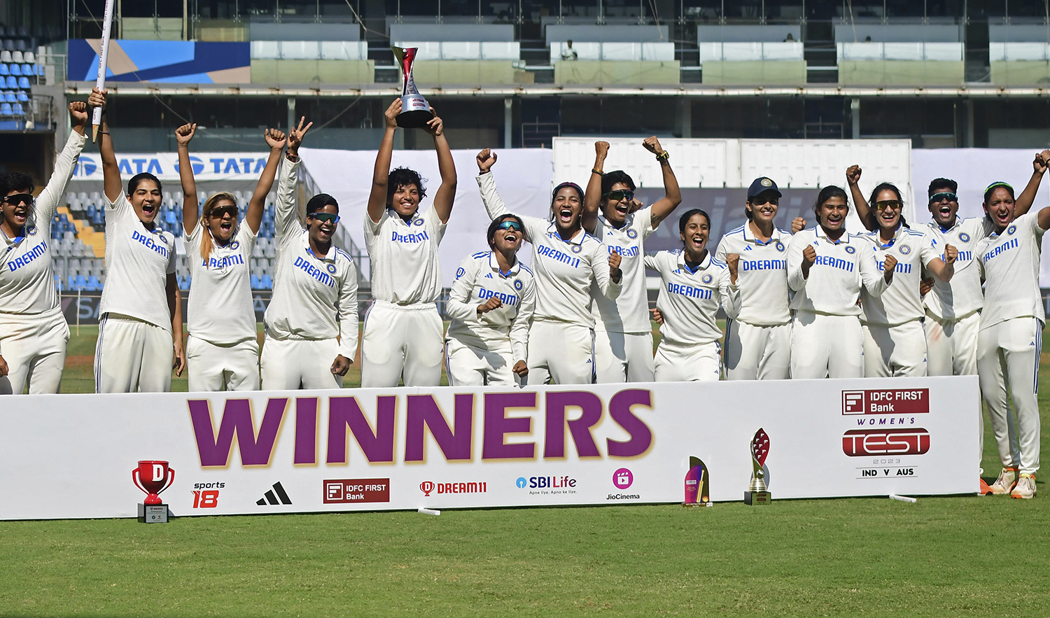 Members of India women team celebrate with the winners trophy after their win in the one off test cricket match against Australia women in Mumbai, India, on December 24, 2023. (AP)