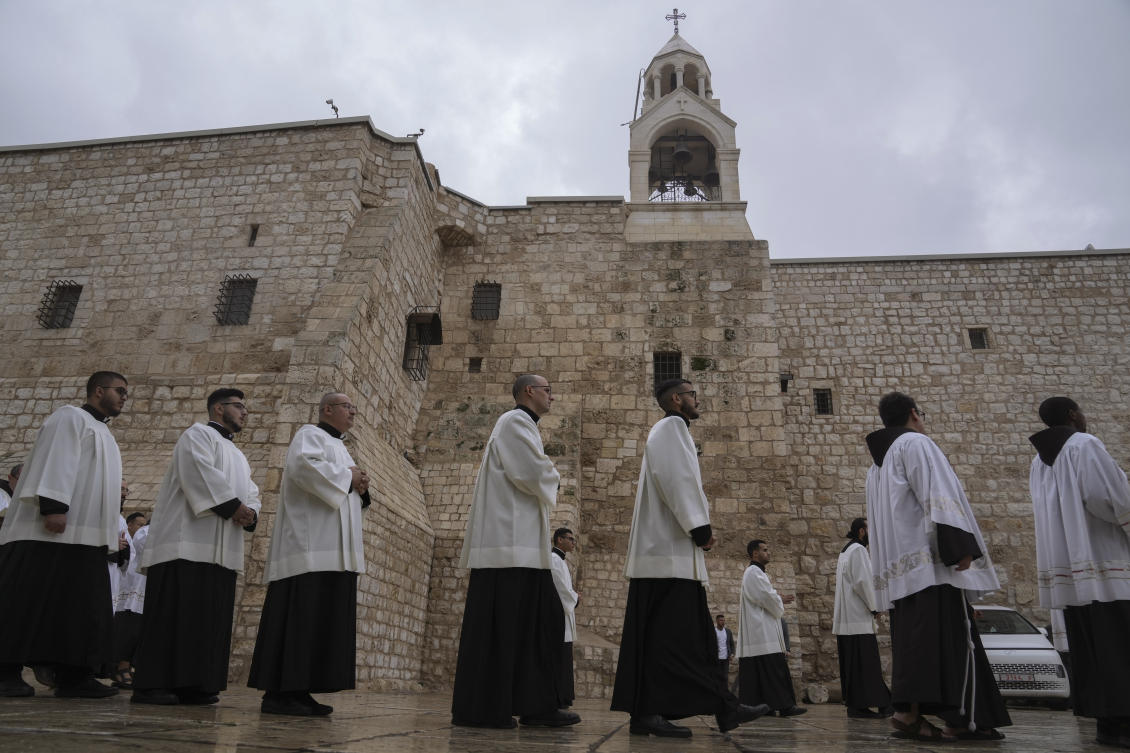 Catholic clergy walk in procession next to the Church of the Nativity, traditionally believed to be the birthplace of Jesus, on Christmas Eve, in the West Bank city of Bethlehem, Sunday, Dec. 24, 2023. (AP)