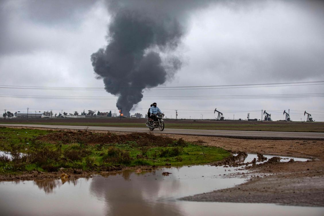 Thick smoke billows from a raging fire at a storage tank of the al-Awda oil field facility near al-Qahtaniyah in northeastern Syria. (AFP)