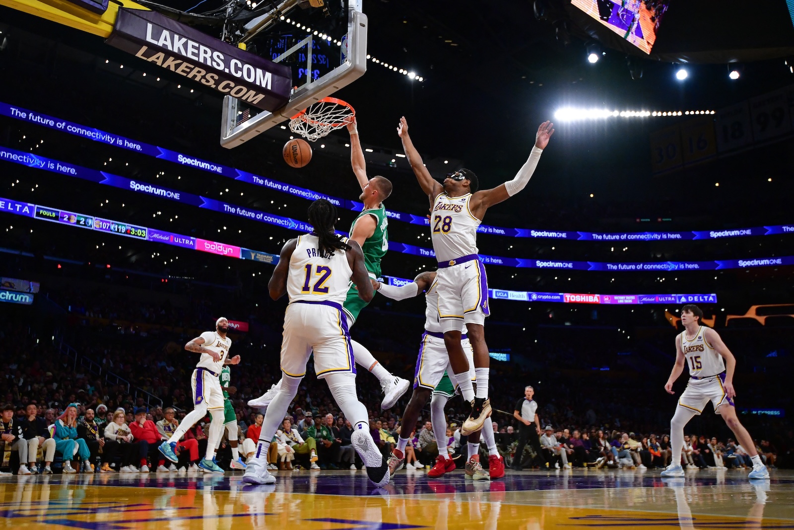 Boston Celtics center Kristaps Porzingis dunks for the basket against Los Angeles Lakers forward Rui Hachimura (28) and forward Taurean Prince (12) during the second half an NBA game at Crypto.com Arena on Dec. 25, 2023. (USA TODAY Sports)