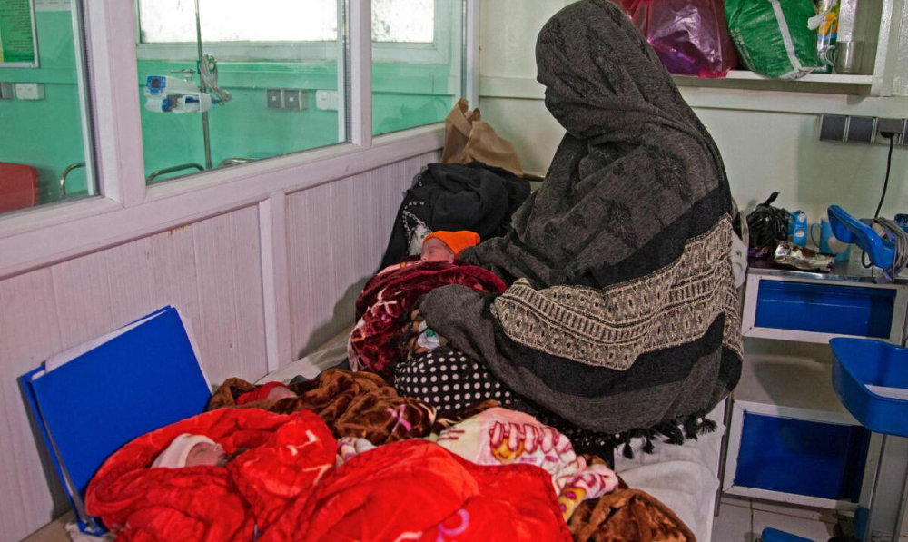 In this photograph taken on December 8, 2023, Islam Bibi, mother of six children and newborn triplets, sits beside her three babies at the Doctors Without Borders (MSF)-run maternity hospital in Khost. (AFP)