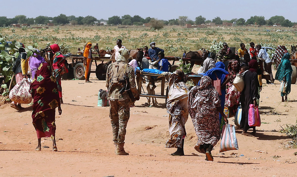Families escaping the violence in Ardamata cross into Chad in early November. Survivors said their homes were ransacked by looters who took TV sets and even doors. (Reuters)