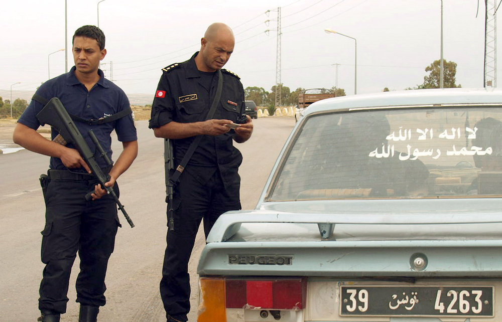 Tunisian security forces check the identification card of a driver in Kasserine. (File/AFP)