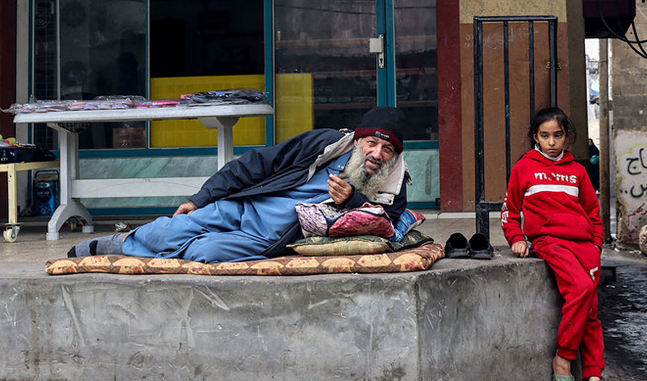 A displaced Palestinian man and child are pictured in Rafah in the southern Gaza Strip on Dec. 27, 2023. (AFP)