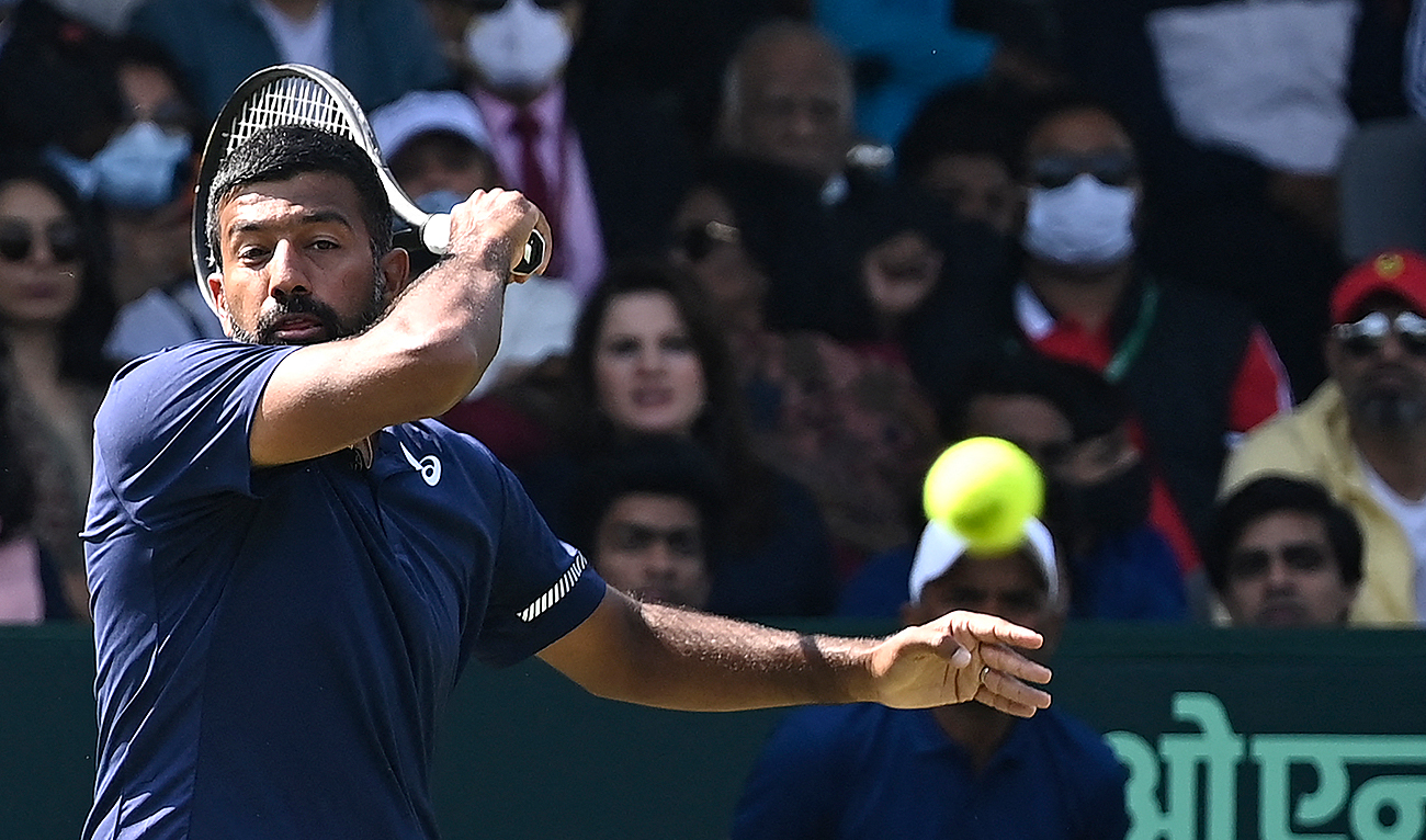 In this file photo, taken on March 5, 2022, India's Rohan Bopanna hits a return against Denmark's Mikael Torpegaard and Frederik Nielsen during their men's doubles tennis match in the Davis Cup in New Delhi. (AFP/File)
