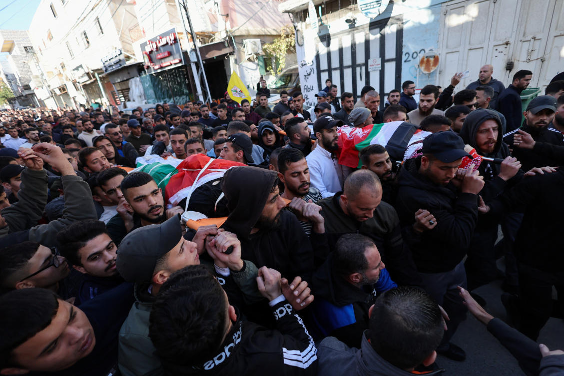 Mourners carry the bodies of Palestinians who were killed in clashes with Israeli troops, during their funeral, in the Fawwar refugee camp near Hebron, in the Israeli-occupied West Bank. (Reuters)
