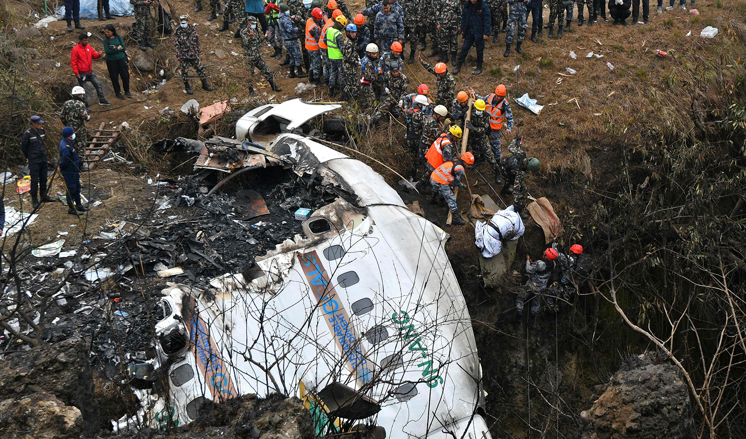 Rescuers pull the body of a victim who died in a Yeti Airlines plane crash in Pokhara, Nepal on January 16, 2023. (AFP/File)