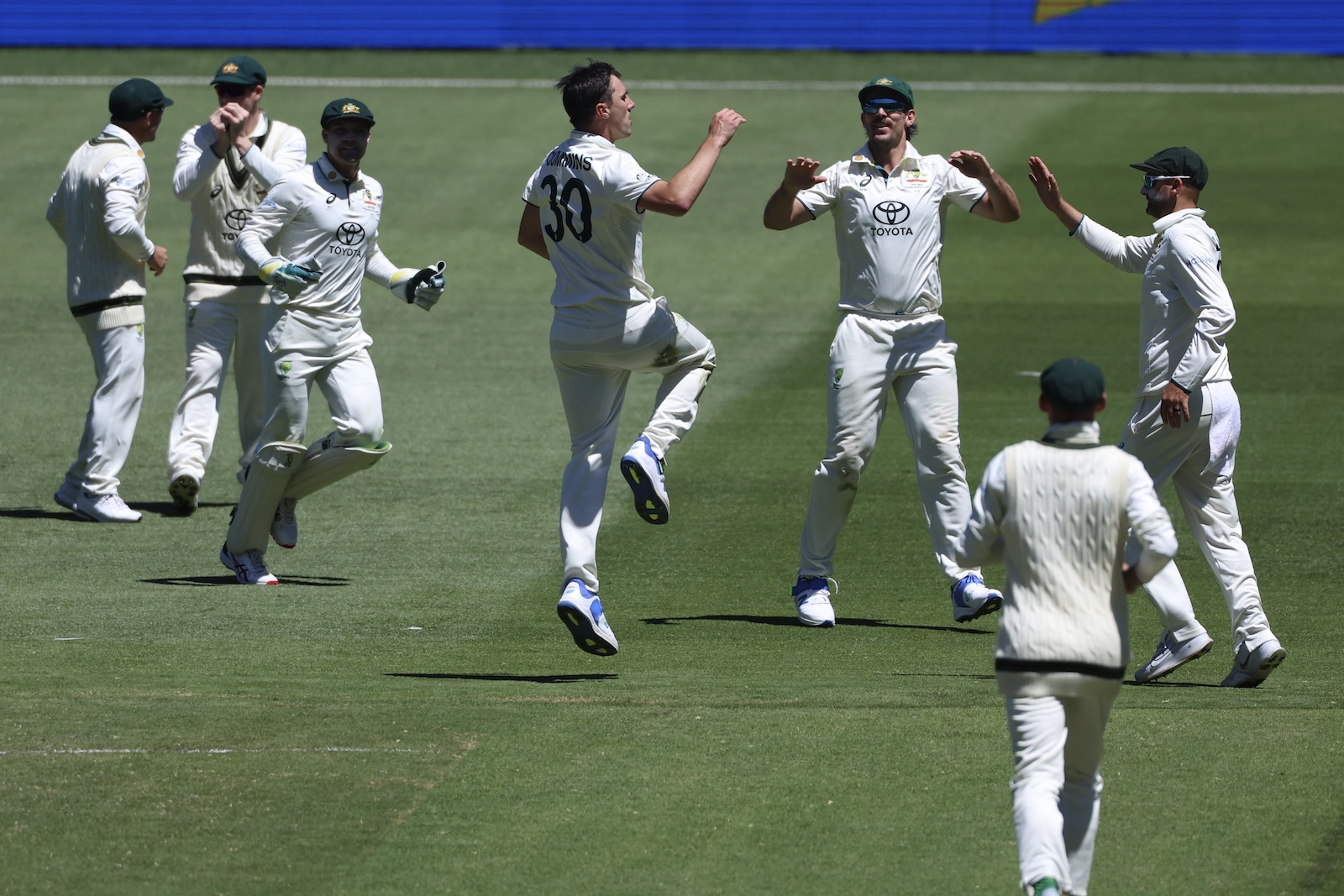 Australia's Pat Cummins, center, celebrates with teammates after dismissing Pakistan's Shan Masood during the fourth day of their cricket Test match in Melbourne Friday. (AP)