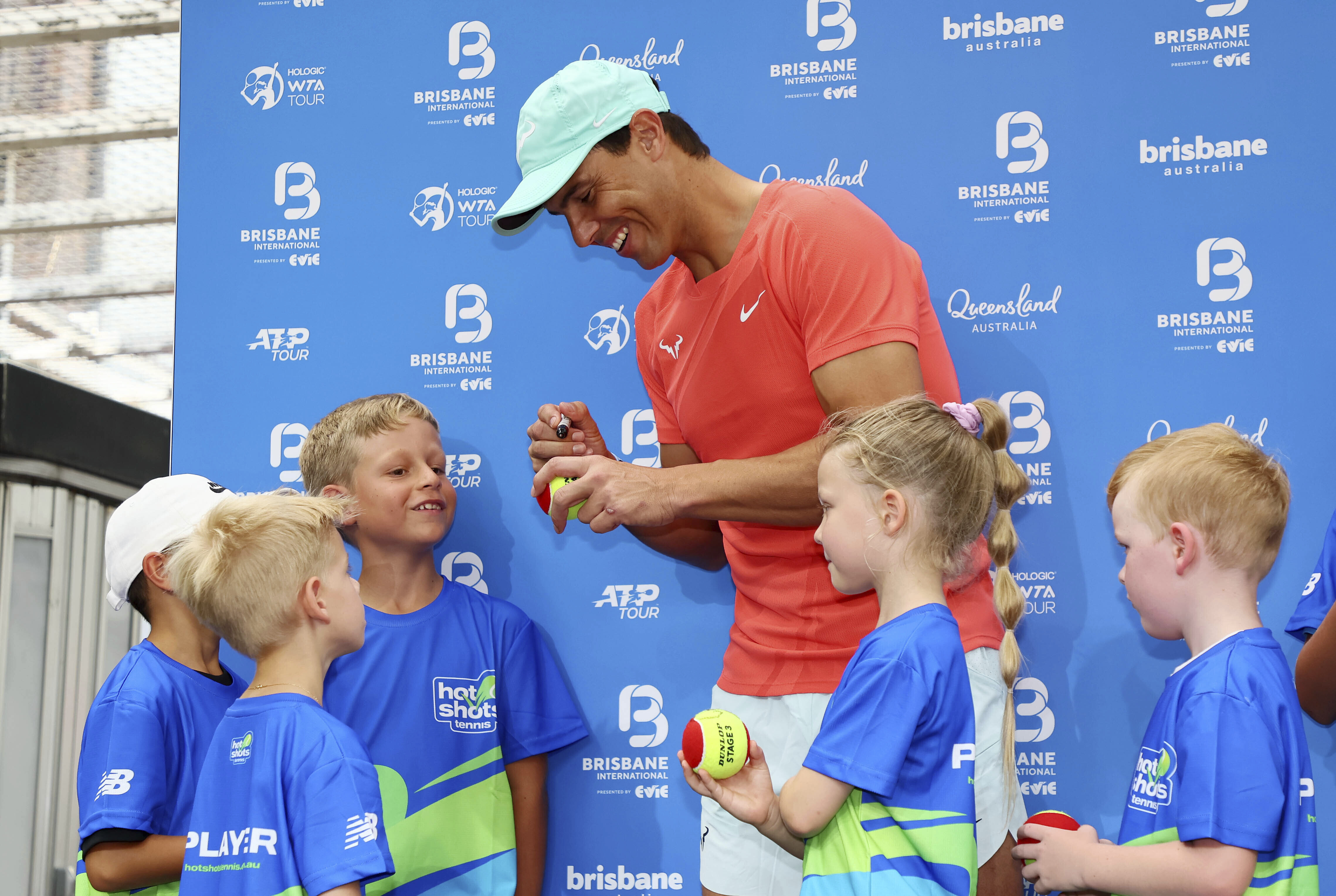 Rafael Nadal of Spain signs tennis balls for young players during a public appearance in the Queen Street Mall ahead of the Brisbane International tennis tournament in Brisbane Friday. (AP)