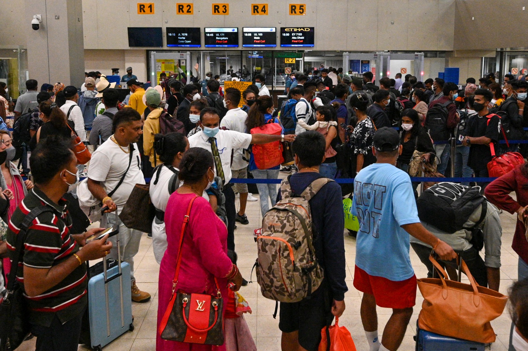 Passengers stand in queues at the Colombo International Airport in Katunayake, Sri Lanka, on Sept. 26, 2022. (AFP)