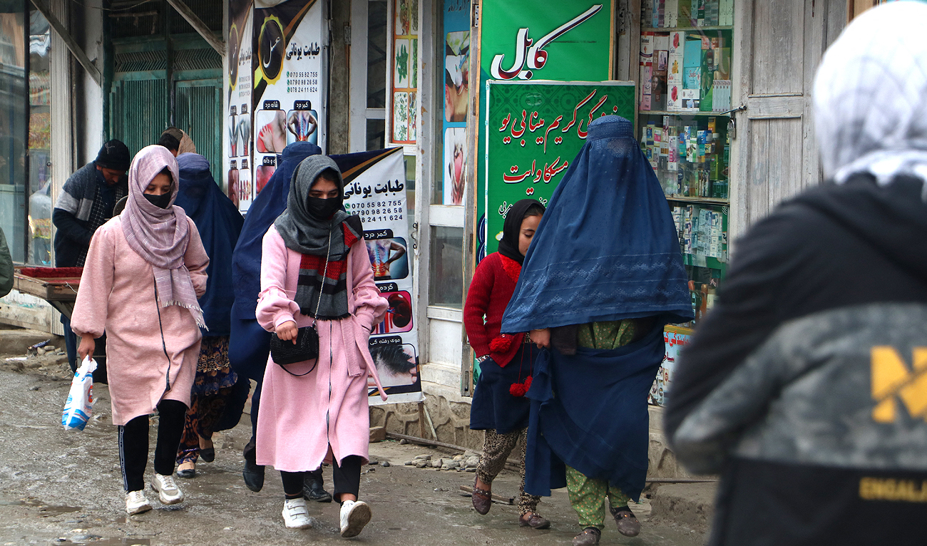 Afghan women walk along a street at a market in the Fayzabad district of Badakhshan province on December 12, 2023. (AFP)