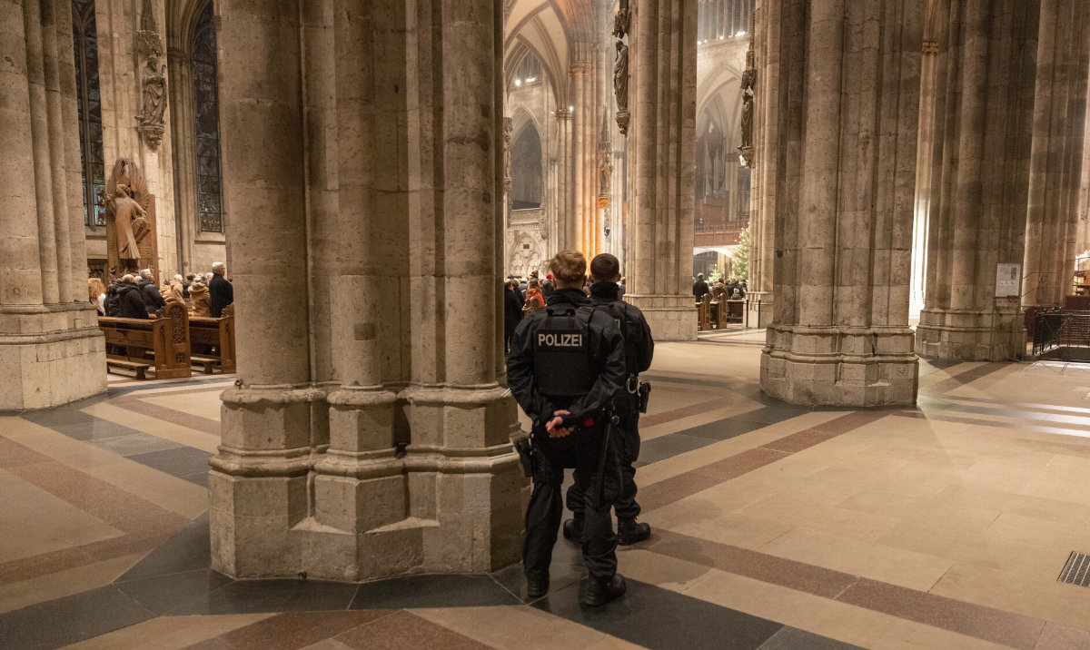 Police officers secure the Cologne Cathedral during the end-of-year pontifical mass in Cologne, Germany, Sunday, Dec. 31, 2023. (AP)