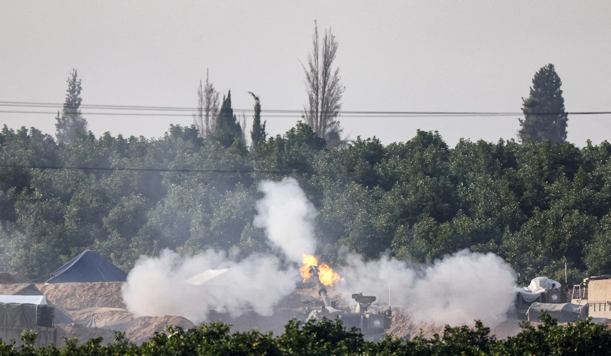 An Israeli tank firing towards the Palestinian territory amid continuing battles between Israel and the militant group Hamas.