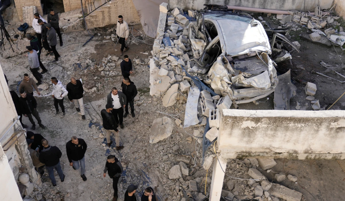 Palestinians look at the aftermath of an Israeli military raid on Jenin refugee camp in the West Bank on Wednesday, Nov. 29, 2023. (AP)