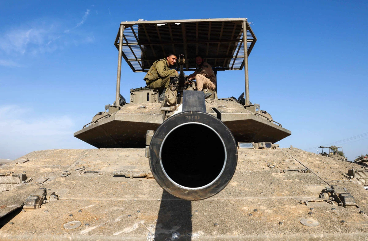 Israeli troops and military vehicles are positioned near the border with the Gaza Strip on December 3, 2023, amid continuing battles between Israel and the militant group Hamas. (AFP)