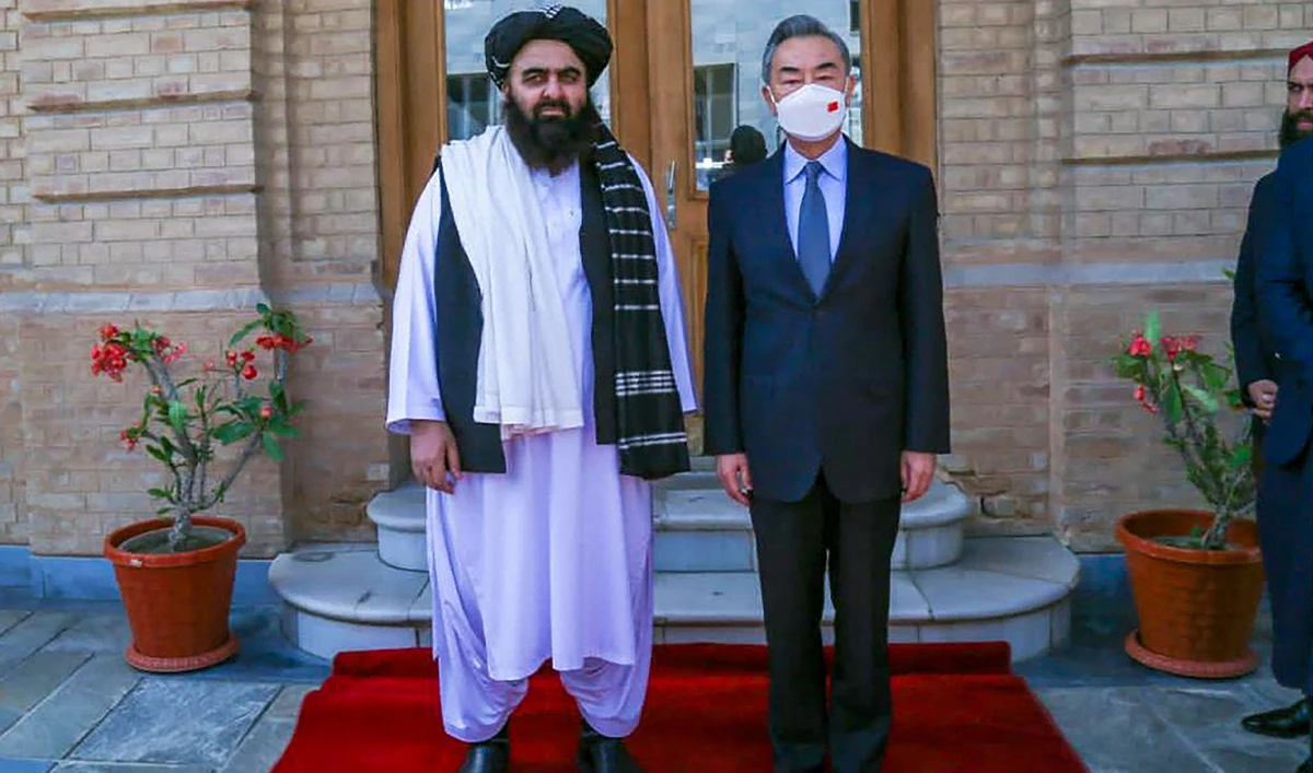 This handout photo released by the Taliban Foreign Ministry shows Taliban Foreign Minister Amir Khan Muttaqi (L) posing with China's Foreign Minister Wang Yi in Kabul on March 24, 2022. (AFP/File)
