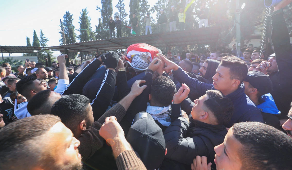 Mourners carry the body of a 38-year-old Palestinian, Ahmad Assi, who was killed in an Israeli settler raid, during his funeral near Salfit in the Israeli-occupied West Bank December 3, 2023. (REUTERS)
