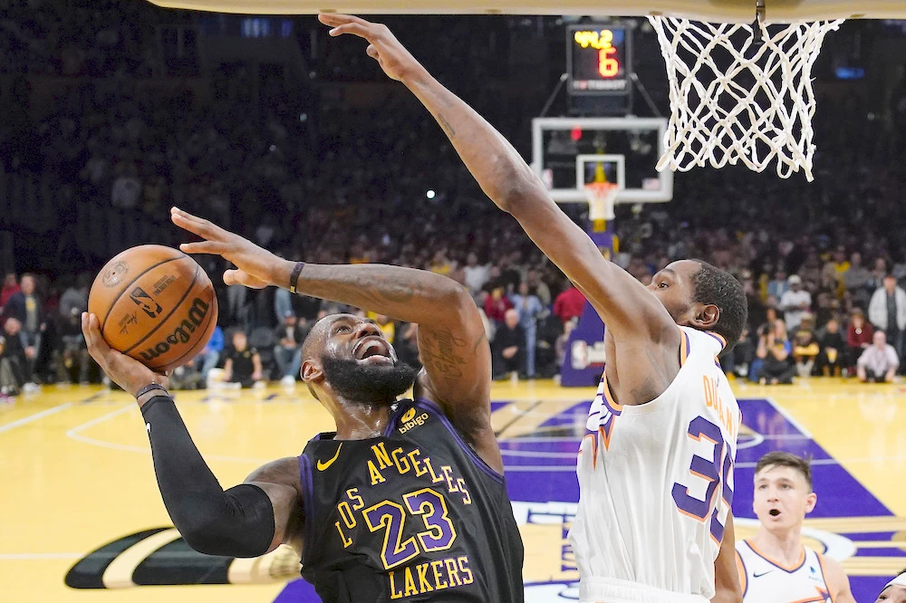 Los Angeles Lakers’ LeBron James shoots against Phoenix Suns’ Kevin Durant during their NBA basketball In-Season Tournament quarterfinal game Tuesday in Los Angeles. (AP)