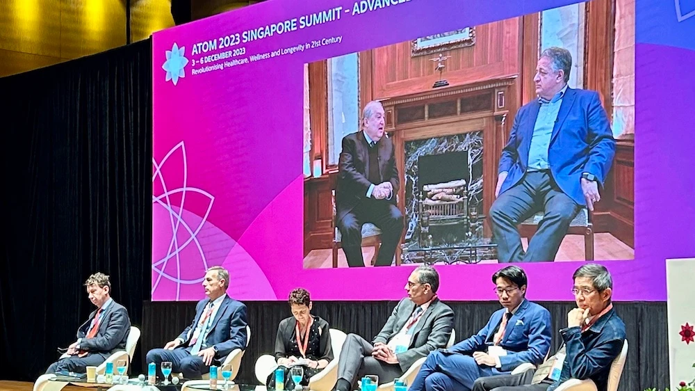 Moderna co-founder Noubar Afeyan, screen right, speaks to Advanced Tomorrow (ATOM) chairman Armen Sarkissian during the ATOM 2023 Singapore Summit at the National University of Singapore on Dec. 4, 2023. (NUS)