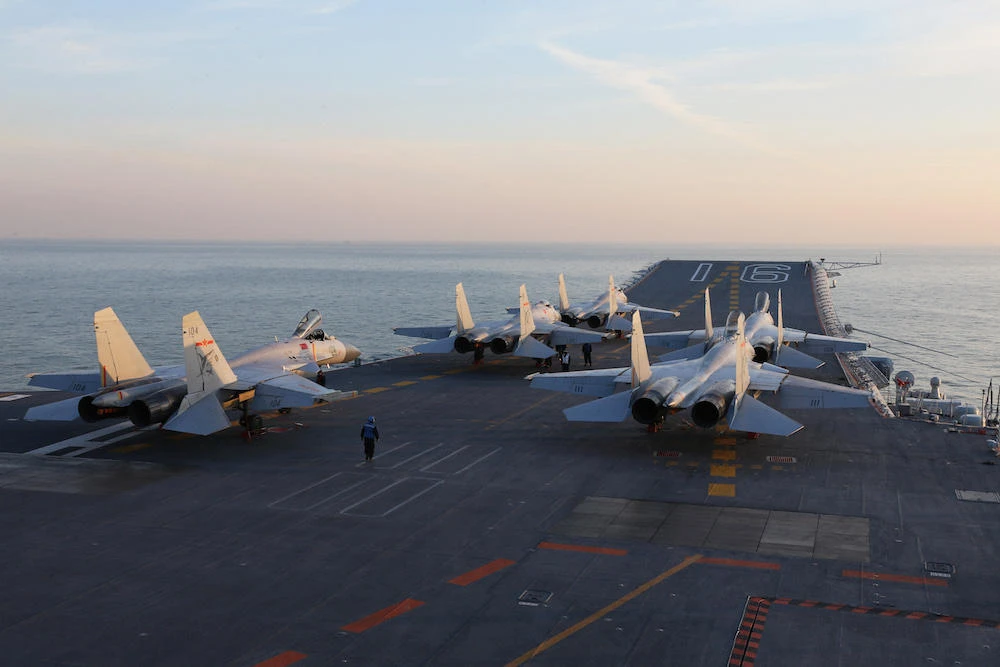 Chinese J-15 fighter jets wait for take-off on the deck of the Liaoning aircraft carrier during military drills in the Bohai Sea in China’s northeast coast in December 2016. (AFP file photo)