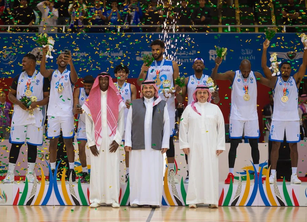 Al-Hilal basketball players celebrate winning gold with Prince Fahad bin Jalawi, center. (Saudi Games)