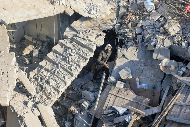 A man walks among the rubble of a building destroyed destroyed Israeli bombardment overnight in Rafah on the southern Gaza Strip on December 7, 2023, amid continuing battles between Israel and the Palestinian militant group Hamas. (AFP)