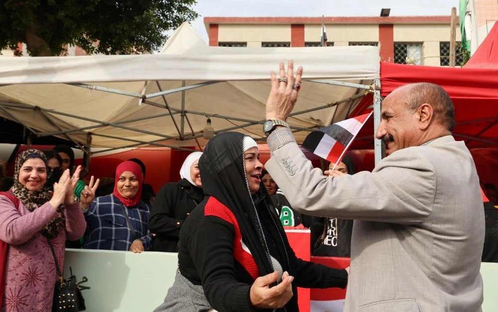 Supporters of presidential candidate and Egyptian President Abdel Fattah El-Sisi dance next to a polling station on the first day of the presidential election in Cairo, Egypt, Dec. 10, 2023. (Reuters)