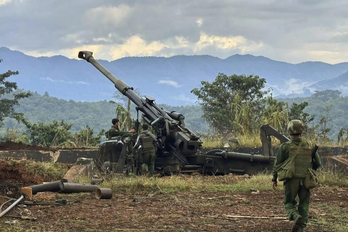 Members of an ethnic armed forces group check weapons the group allegedly seized from Myanmar’s army outpost on a hill in Hsenwi township in Shan state on Nov. 24, 2023. (The Kokang online media via AP)