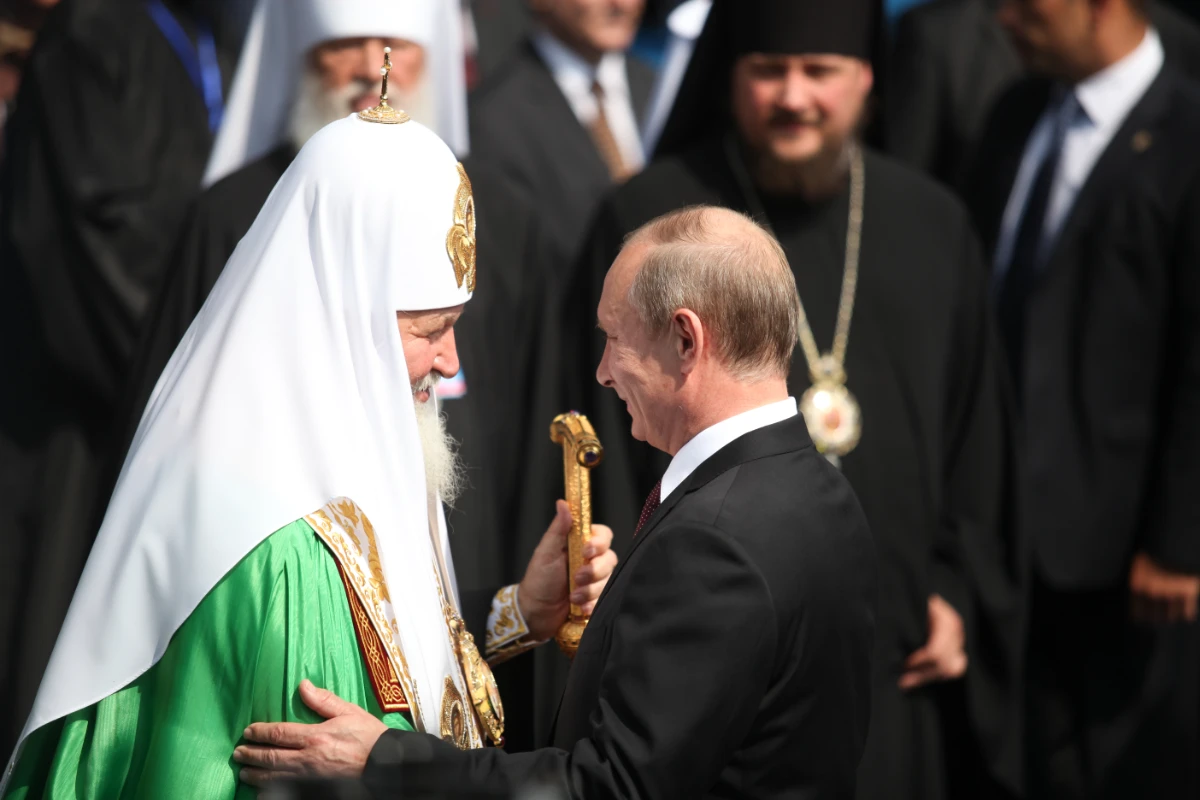 A file photo taken in July 2013 shows the head of the Russian Orthodox Church in Ukraine, Patriarch Kirill, sharing joyous moments with Russian President Vladimir Putin during a religious celebration in Kyiv. (Shutterstock)