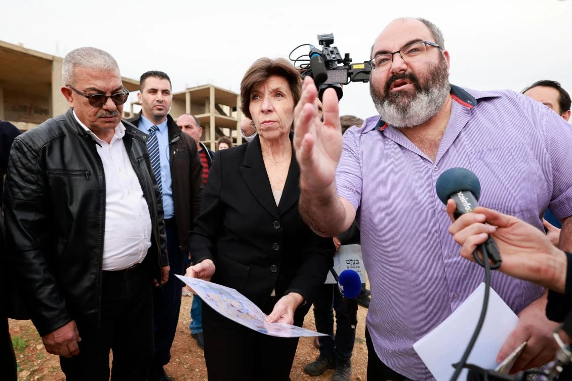 French Foreign Minister Catherine Colonna (C) meets with Palestinian olive growers in a small village near Ramallah in the occupied West Bank on December 17, 2023, amid the ongoing conflict in Gaza between Israel and the militant group Hamas. (AFP)