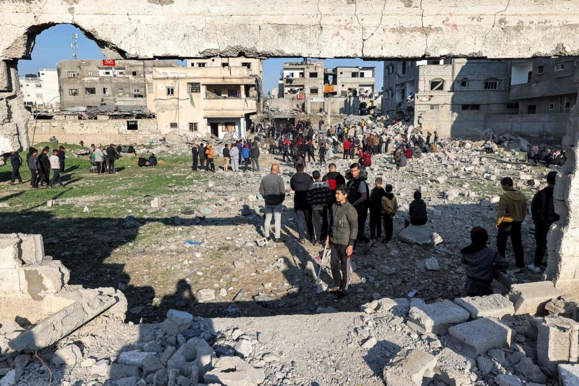 People gather to inspect the rubble of a building destroyed by Israeli bombardment in Rafah in the southern Gaza Strip on Dec. 19, 2023. (AFP)