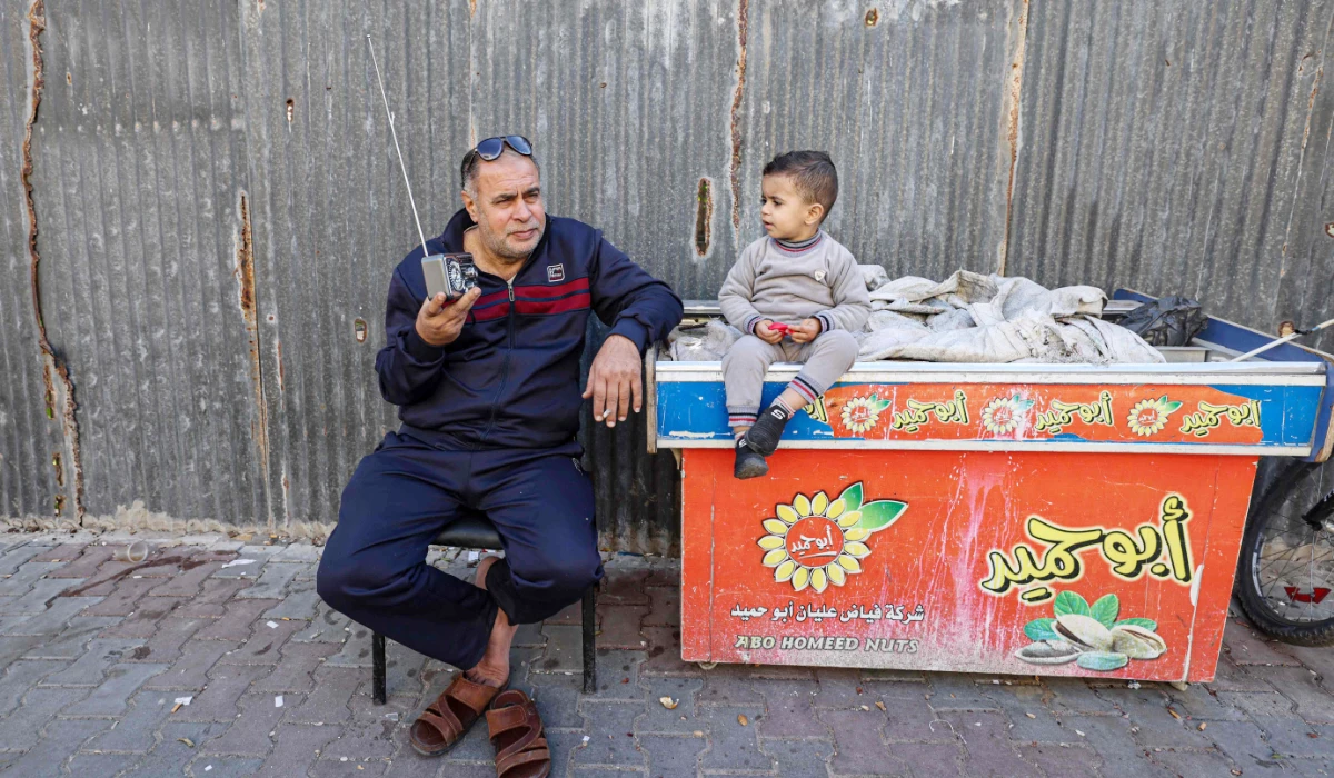A Palestinian man listens to his radio in a refugee camp in Rafah in the southern Gaza Strip amid continuing battles between Israel forces and Hamas fighters. (AFP)