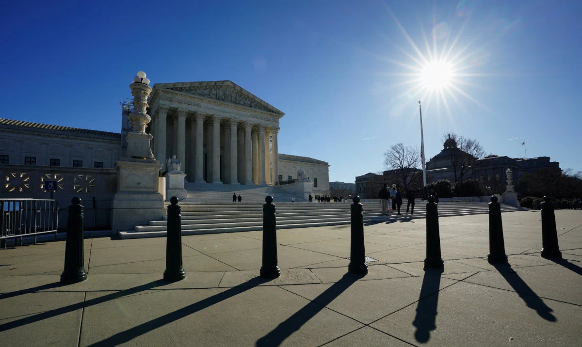 The sun casts shadows as it rises over the US Supreme Court in Washington, US, December 20, 2023. (Reuters)