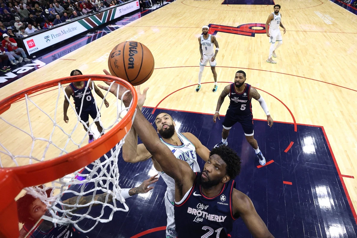 Joel Embiid of the Philadelphia 76ers reaches for a rebound past Rudy Gobert of the Minnesota Timberwolves during the fourth quarter of an NBA game at the Wells Fargo Center on Dec. 20, 2023 in Philadelphia, Pennsylvania. (GETTY IMAGES NORTH AMERICA / AFP)