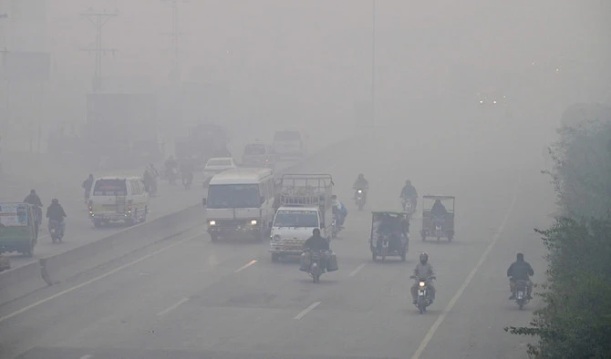 Commuters drive along a road amid dense smog in Lahore, Pakistan on November 24, 2023. (AFP/File)