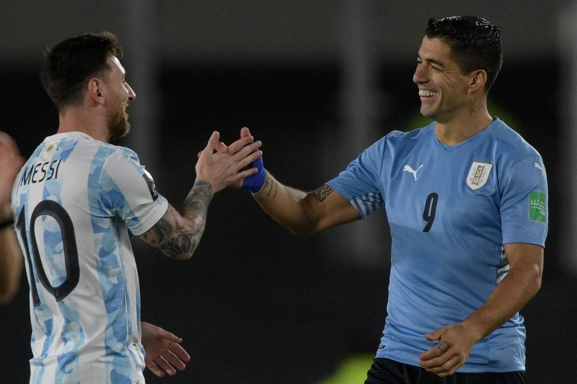 Argentina’s Lionel Messi greets Uruguay’s Luis Suarez before the start of the South American qualification match for the FIFA World Cup Qatar 2022, at the Monumental stadium in Buenos Aires, on Oct. 10, 2021. (AFP/File)