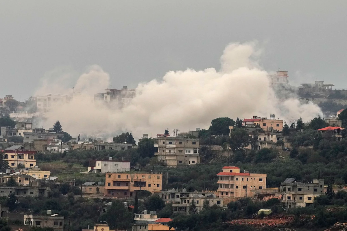 Smoke rises from Israeli artillery shelling on Aita al-Shaab, a Lebanese border village with Israel, in south Lebanon, Saturday, Dec. 9, 2023. (AP Photo/Hassan Ammar)