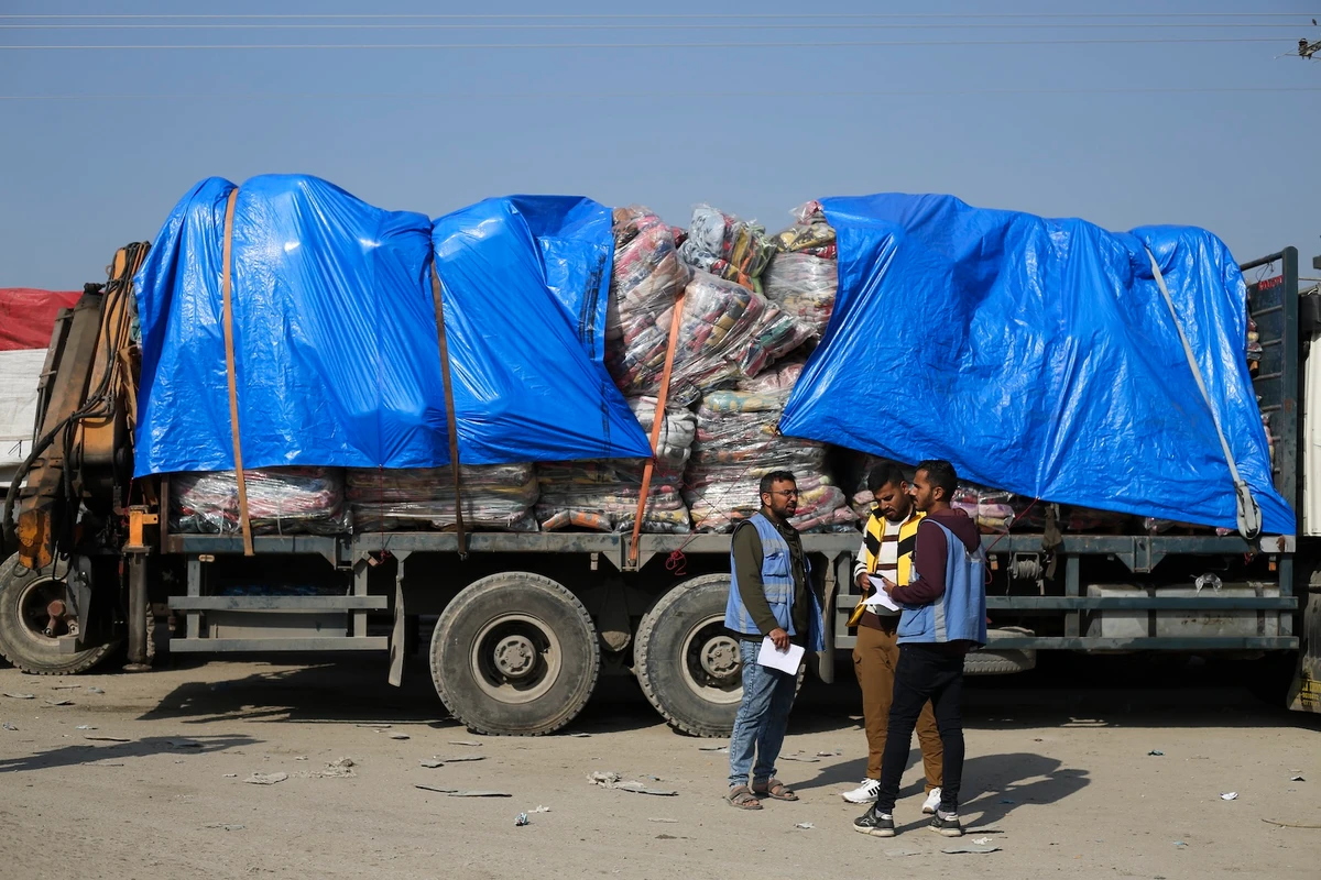 Humanitarian aid trucks enter through the Kerem Shalom crossing from Israel into the Gaza Strip on Monday, Dec. 18, 2023. (AP)