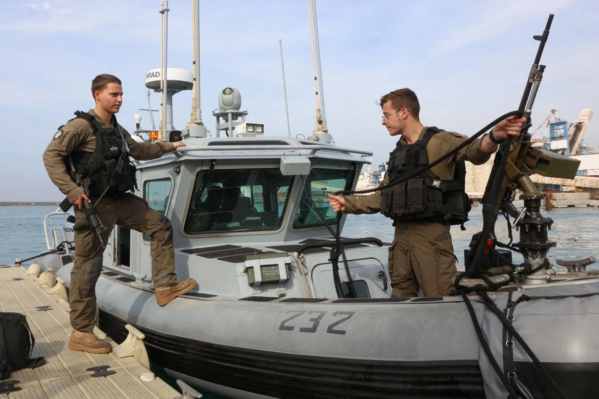 Israeli navy soldiers prepare navy ship "Snapir" before setting out to the Mediterranean sea waters around the Gaza Strip, at the Israeli naval base in Ashdod, amid continuing battles between Israel and the militant group Hamas (AFP)