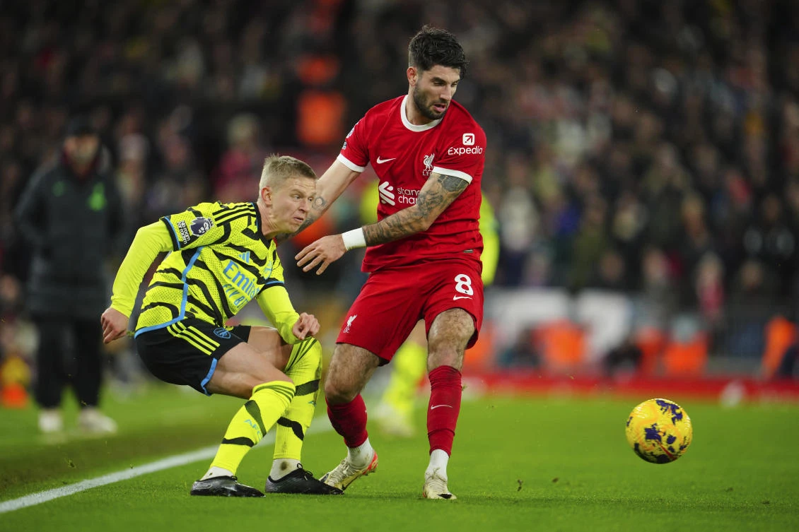 Arsenal’s Oleksandr Zinchenko is challenged by Liverpool’s Dominik Szoboszlai during their English Premier League match at Anfield stadium in Liverpool on Dec. 23, 2023. (AP)