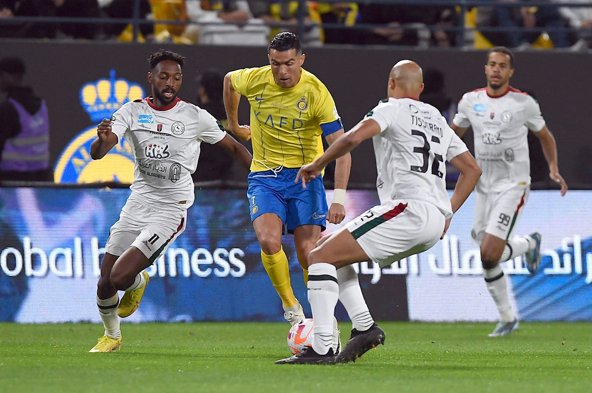 Al Nassr's Cristiano Ronaldo in action with Al Ettifaq's Ali Hazazi and Marcel Tisserand at Al-Awwal Park in Riyadh on December 22, 2023. (REUTERS)