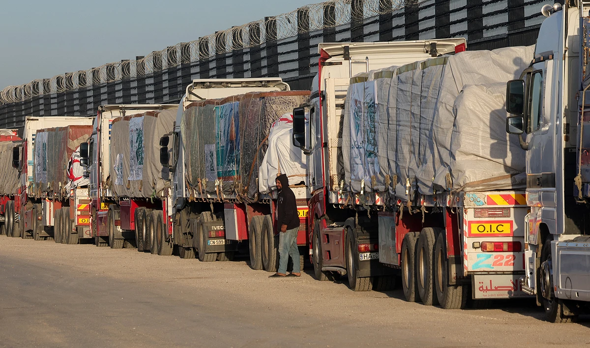 Trucks with humanitarian aid wait to enter the Palestinian side of Rafah on the Egyptian border with the Gaza Strip on December 11, 2023. (AFP/File)