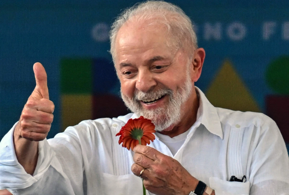 Brazilian President Luiz Inacio Lula da Silva gives his thumb up holding a flower during the visit to the premise where the Copa do Povo housing complex will be built, in São Paulo, Brazil, on Dec. 16, 2023. (AFP)