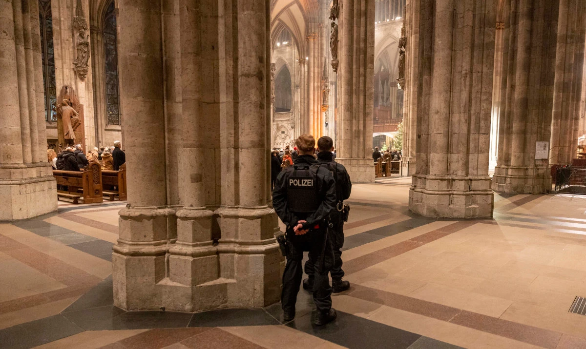Police officers secure the Cologne Cathedral during the end-of-year pontifical mass in Cologne, Germany, Sunday, Dec. 31, 2023. (AP)