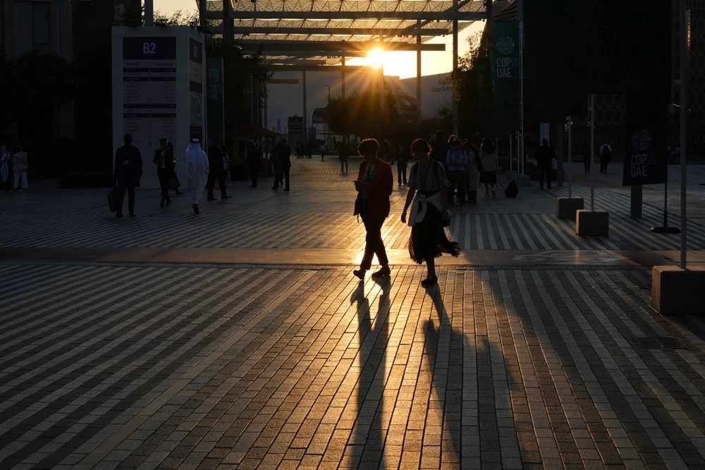 People walk through the COP28 U.N. Climate Summit, Tuesday, Dec. 5, 2023, in Dubai, United Arab Emirates. (AP)